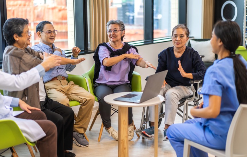 Portrait of asian woman physiotherapist trainer carer help physical and discussing consulting with group asian senior patient by doing yoga workout exercises in rehabilitation at hospital.healthcare